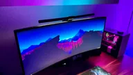 Quntis RGB Pro on an ultrawide monitor next to a gaming desktop PC.